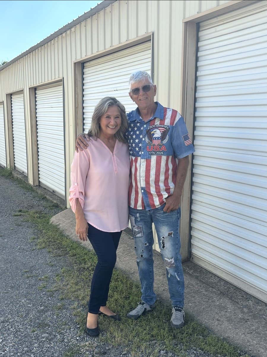Pat and family standing in front of 59 Mini Storage units